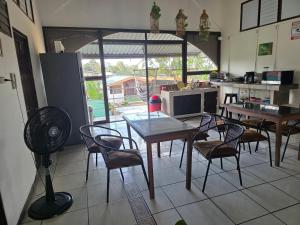a kitchen with a table and some chairs and a table at Fortuna garden hotel in Fortuna +19 photos