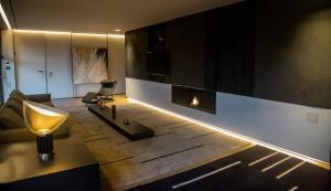a living room with a fireplace and a couch at Bilor Luxury Holidays in Subbiano