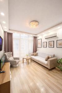 a living room with a couch and a table at dupleqs batumi daRia in Angisa