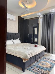 a bedroom with a large bed in a room at Sukhhin Chandigarh in Zirakpur