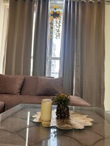 a living room with a couch and a candle on a table at Sukhhin Chandigarh in Zirakpur