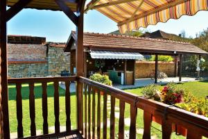 a porch with a deck with a building at The Village Cottage in Natsovtsi