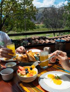 a group of people sitting at a table eating breakfast at Casa Eva Hotel Boutique in Urubamba