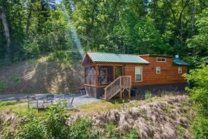a tiny house in the middle of a forest at Cedar Heights Tiny House Log Cabin in Bryson City