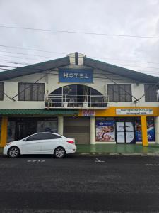 a white car parked in front of a hotel at Fortuna garden hotel in Fortuna