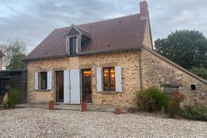 a stone house with white doors and windows at La Maison de Fougerolles, Renovated farmhouse in Fougerolles