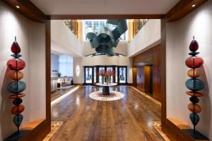 a large lobby with a table in the middle at Conrad Hamburg in Hamburg