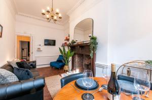 a living room with a table and a couch at Cobb's Margate Old Town Hideaway in Margate