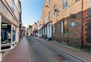 an empty street in an alley with brick buildings at Cobb's Margate Old Town Hideaway in Margate
