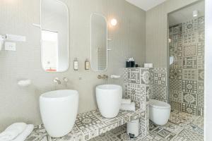 a bathroom with two sinks and a mirror at Boutique Hotel Miramar in Monte Carlo