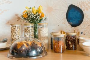 a table with jars of seeds and a vase of flowers at Boutique Hotel Miramar in Monte Carlo
