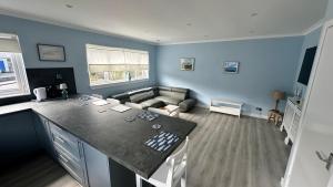 a kitchen and living room with a couch in a room at 3 bedroom cottage in Lamlash