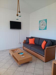 a living room with a blue couch and a coffee table at Naxos olive & home in Engares