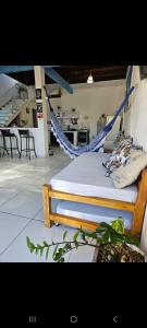 a bed with a hammock in a room at Casa Valhalla Pipa in Pipa