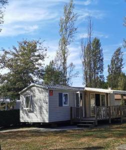 a tiny house with a porch and a deck at Camping des Abesses in Saint-Paul-lès-Dax