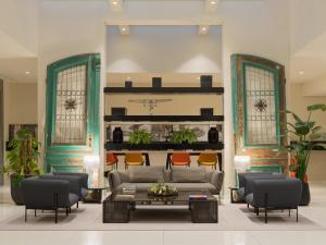 a living room with a couch and chairs at H10 Berlin Ku'Damm in Berlin