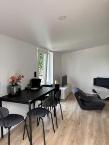 a dining room with a black table and chairs at Comfy House Privé in Erftstadt
