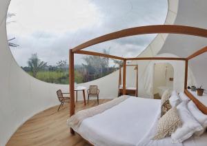 a bedroom with a large bed in a tent at Green Land Bubble Glamping in Cabarete