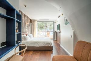 a bedroom with a bed and a large window at Boutique Hotel Miramar in Monte Carlo