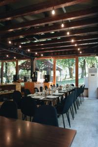 a dining room with a long table and chairs at Arsenal Park Transilvania in Orăştie