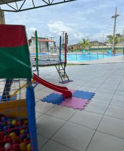 a playground with a slide and a swing at Aeroporto Manaus in Manaus