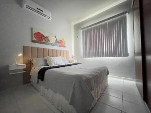 a bedroom with a large bed with a window at Aeroporto Manaus in Manaus +13 photos