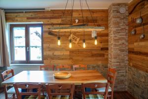 a dining room with a wooden table and chairs at Affittacamere ai 4 venti in Arta Terme