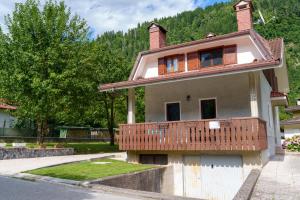 a house with a balcony on top of it at Affittacamere ai 4 venti in Arta Terme
