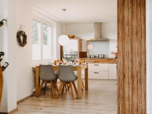 a kitchen with a wooden table and chairs at Hillside Braunlage in Braunlage