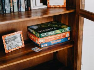 a stack of board games on a book shelf at Hillside Braunlage in Braunlage