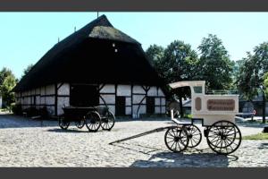 two horse drawn carriages parked in front of a building at Zentrale Monteurwohnung in Oldenburg i H in Oldenburg in Holstein +5 photos