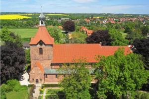 an aerial view of a church with an orange roof at Zentrale Monteurwohnung in Oldenburg i H in Oldenburg in Holstein