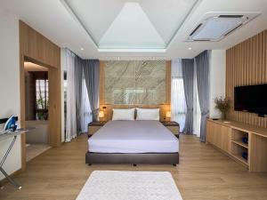 a bedroom with a large bed and a television at Luxury 3BR Pool Villa Private Pool Quiet Area in Ban Klang +25 photos