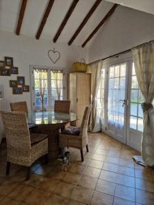 a dining room with a glass table and chairs at Charming house just a few minutes from the beach in Sainte-Maxime