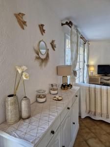 a room with a table with a mirror on the wall at Charming house just a few minutes from the beach in Sainte-Maxime