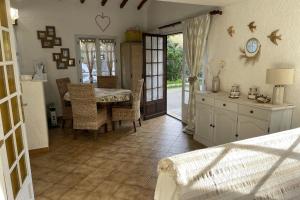 a kitchen with a table and a dining room at Charming house just a few minutes from the beach in Sainte-Maxime