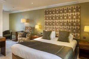 a hotel room with a bed and a chair at Ringwood Hall Hotel & Spa, Best Western Signature Collection in Chesterfield