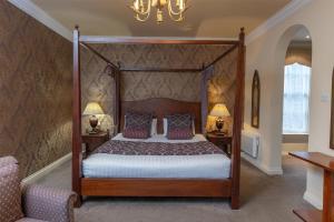 a bedroom with a canopy bed and two lamps at Ringwood Hall Hotel & Spa, Best Western Signature Collection in Chesterfield