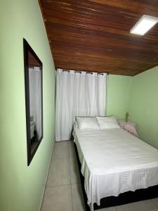 a small bedroom with a bed and a window at Aquarium Rooms in Floridablanca +55 photos