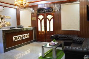 a living room with a couch and a table at Hotel Grand Orchard in Lahore