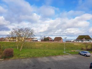 a car parked in a parking lot next to a field at FeWo Krüger 17 in Dahme
