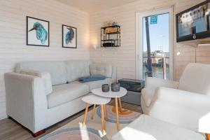 a living room with a couch and two chairs at Snowbird in Lübeck