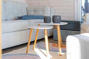 two tables in a living room next to a couch at Snowbird in Lübeck