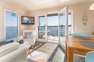 a living room with a view of the water at Snowbird in Lübeck
