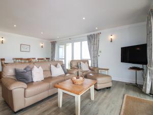 a living room with a couch and a tv at 7 Thurlestone Rock in Kingsbridge