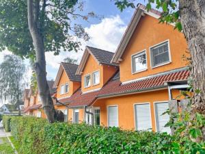 a row of orange houses with windows at Rügenglück in Breege