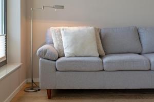 a couch with two pillows on it in a living room at Gemütliches Ferienhaus in Scharbeutz