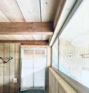 a window in a room with wooden walls and a ceiling at Respiro in Paris +37 photos