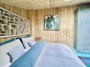 a bedroom with a bed in a wooden wall at Respiro in Paris