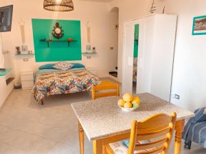 a bedroom with a bed and a table with a bowl of fruit at Il Nido sullo Scoglio in Bonassola